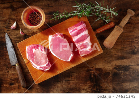 Pork meat, overhead flat lay shot with rosemary Pork meat, overhead flat lay shot with rosemary 74621345