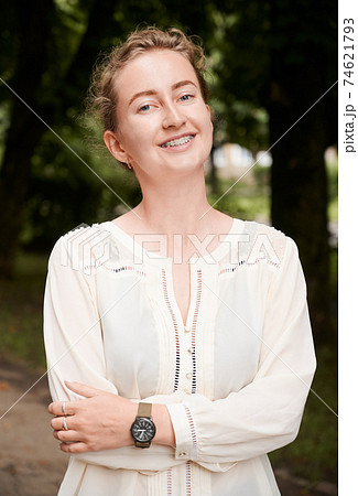 Portrait of a smiling girl outdoors, demonstrating beautiful teeth with braces Portrait of a smiling girl outdoors, demonstrating beautiful teeth with braces 74621793