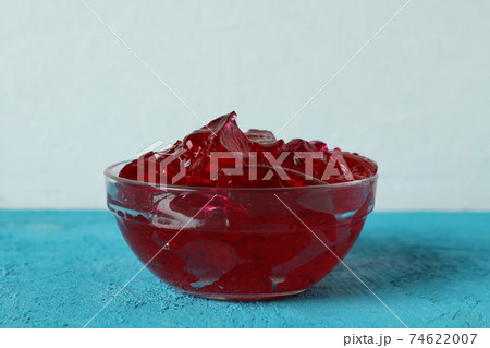 Bowl of strawberry jelly on blue table Bowl of strawberry jelly on blue table 74622007
