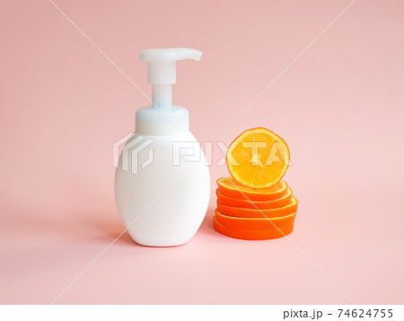White unbranded bottle with pump and orange slices on light pink background. Blank container for lotion, cream, sunscreen, shampoo or hair conditioner. Mockup style, cosmetic products advertising White unbranded bottle with pump and orange slices on light pink background. Blank container for lotion, cream, sunscreen, shampoo or hair conditioner. Mockup style, cosmetic products advertising 74624755