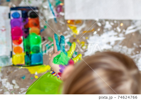 Little girl using watercolour at home during the pandemic lockdown 74624766