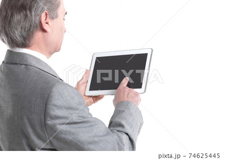 close up.the businessman points to the tablet screen.rear view.isolated on white background close up.the businessman points to the tablet screen.rear view.isolated on white background 74625445