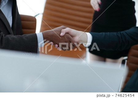 closeup.handshake of business partners on the background of the office 74625454