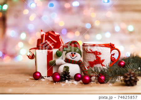 Cup with Christmas ornament,Christmas gifts and a cheerful snowm Cup with Christmas ornament,Christmas gifts and a cheerful snowm 74625857