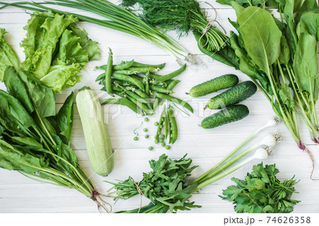 Composition on a dark background of green organic vegetarian products 74626358