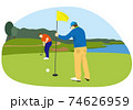 グリーンでパッティングする男性ゴルファーとピンを持つ同伴ゴルファー（背景あり） 74626959