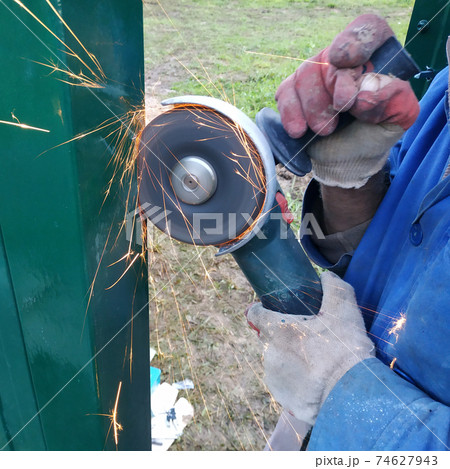 Cutting of a metal fence by means of the grinding corner car, installation of a fence and construction works. 74627943