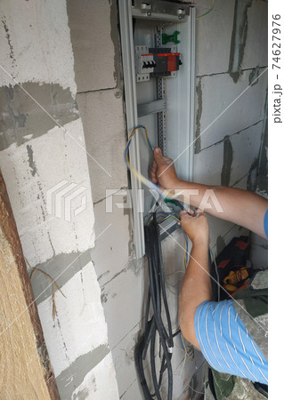 Electrical switchboard and cables to the switchboard, installation of electricity in the house. 74627976