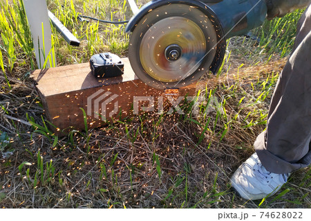 Cutting bricks with an angle grinder, construction work, the process of execution close-up. 74628022