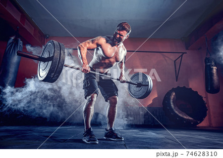 Muscular man working out in gym doing exercises, strong male naked torso abs Muscular man working out in gym doing exercises, strong male naked torso abs 74628310