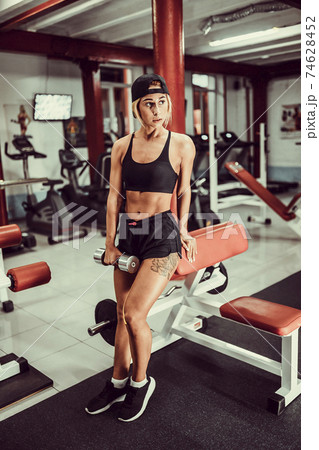 Fit girl exercise in gym. 74628452