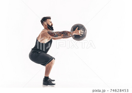 Muscular tattooed bearded male exercising fitness weights Medici Muscular tattooed bearded male exercising fitness weights Medici 74628453