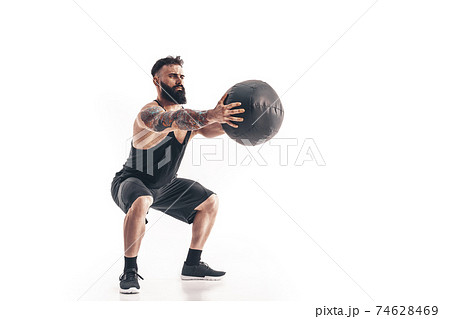 Muscular tattooed bearded male exercising fitness weights Medici Muscular tattooed bearded male exercising fitness weights Medici 74628469