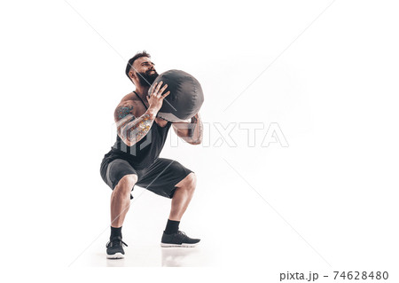 Muscular tattooed bearded male exercising fitness weights Medici Muscular tattooed bearded male exercising fitness weights Medici 74628480