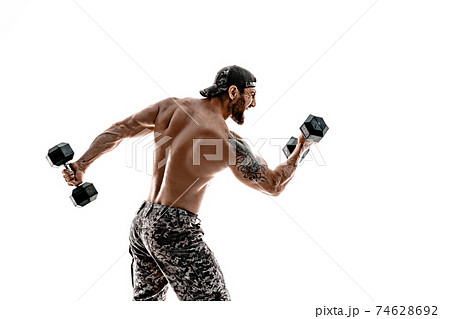 Muscular athlete bodybuilder man in camouflage pants with a nake 74628692