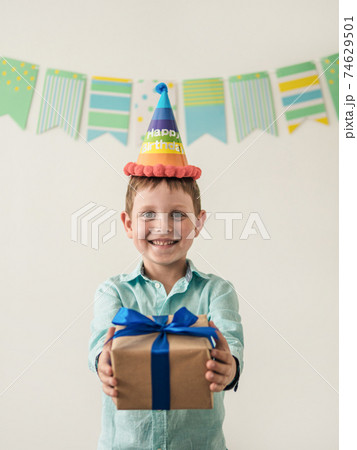 Five year old boy in his birthday hold gift box 74629501