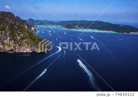 Top view of isolated rocky tropical island with turquoise water and white beach. 74630322