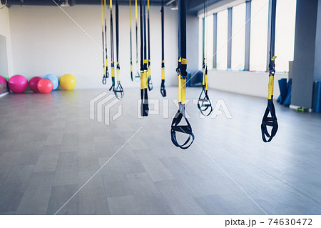 Fitness straps for working with own weight in gym, no people Fitness straps for working with own weight in gym, no people 74630472