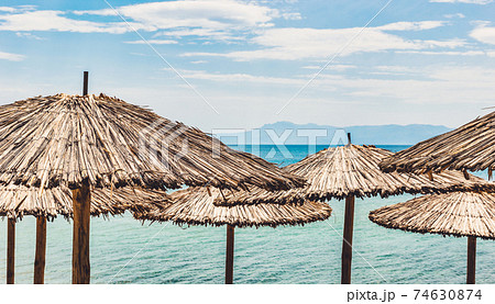 Straw umbrellas on tropical beach Straw umbrellas on tropical beach 74630874