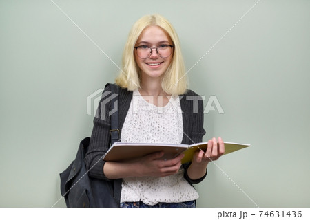 Portrait of happy student girl teenager 16 years old in glasses with backpack Portrait of happy student girl teenager 16 years old in glasses with backpack 74631436