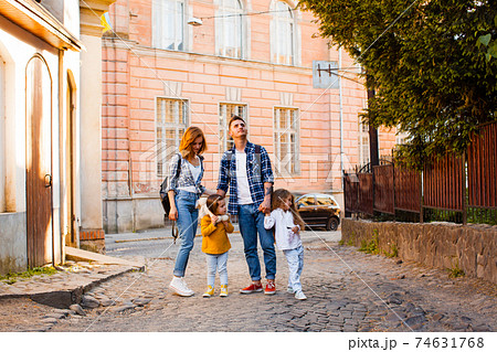 The family are walking around the old town at the summer 74631768