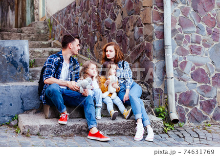 the young family are resting while walking the old city the young family are resting while walking the old city 74631769