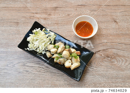 fried squid egg or gonad with chop fresh cabbage on plate dipping spicy and sour sauce 74634029