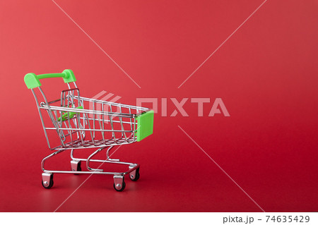 Empty supermarket shopping grocery cart on colored background 74635429