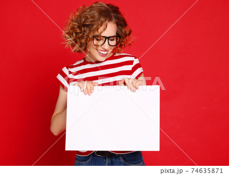 Happy female with at blank poster Happy female with at blank poster 74635871