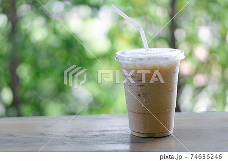 Close up glass of ice americano coffee on wood table, selective focus 74636246