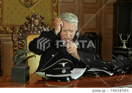 Military mature general calls on the phone in his office Military mature general calls on the phone in his office 74638564