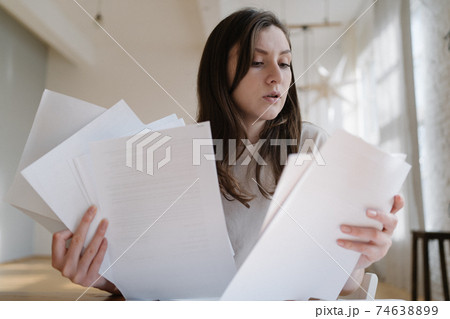 Overload with paperwork. Employed worker on the remote work at home 74638899