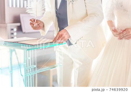 結婚式で署名をする新郎新婦の写真素材