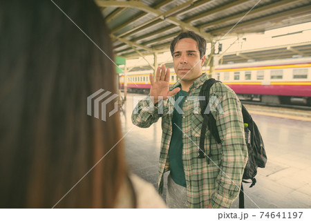 Persian tourist man and young Asian tourist woman together at the railway station Persian tourist man and young Asian tourist woman together at the railway station 74641197
