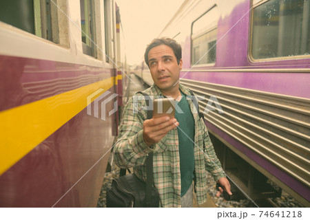 Handsome Persian tourist man at the railway station in Bangkok, Thailand Handsome Persian tourist man at the railway station in Bangkok, Thailand 74641218