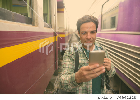 Handsome Persian tourist man at the railway station in Bangkok, Thailand Handsome Persian tourist man at the railway station in Bangkok, Thailand 74641219