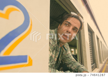 Handsome Persian tourist man at the railway station in Bangkok, Thailand 74641287