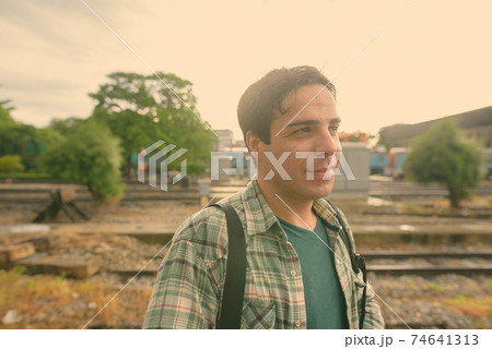 Handsome Persian tourist man at the railway station in Bangkok, Thailand 74641313