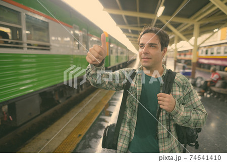 Handsome Persian tourist man at the railway station in Bangkok, Thailand Handsome Persian tourist man at the railway station in Bangkok, Thailand 74641410