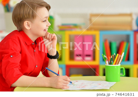 Portrait of cute little boy drawing with pencils Portrait of cute little boy drawing with pencils 74641631
