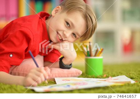 Close-up portrait of cute little boy drawing 74641657
