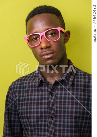 Face of young African hipster man with eyeglasses 74642433