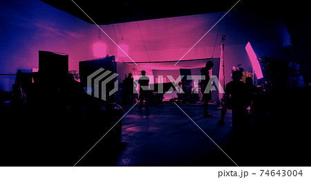 Behind the scenes of shooting video production and lighting set for filming movie which film crew team working in silhouette and professional equipment in studio for video online. video production con Behind the scenes of shooting video production and lighting set for filming movie which film crew team working in silhouette and professional equipment in studio for video online. video production con 74643004