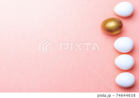 Easter message. Golden, white colour egg on pastel pink background in Happy Easter decoration. Foil minimalist egg design, modern top view template. 74644638