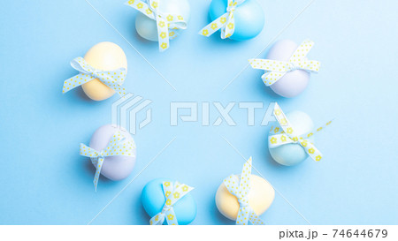 Easter set. Colorful egg with tape ribbon on pastel blue background in Happy Easter decoration. Traditional design with copy space. 74644679