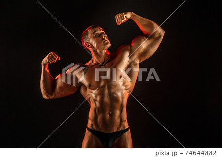 Portrait of shirtless muscular man with arm up Portrait of shirtless muscular man with arm up 74644882