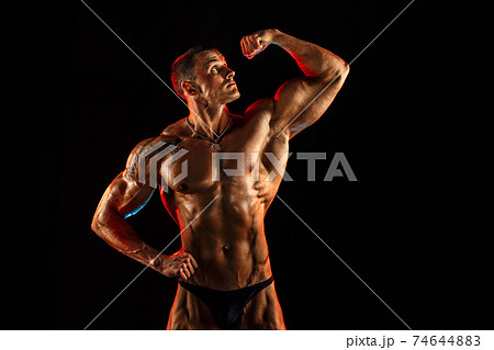 Portrait of shirtless muscular man with arm up 74644883