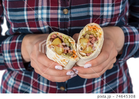 Woman's hand holds shawarma kebab on a white background. Isolated 74645308