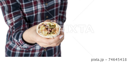 Female hands hold doner kebab, shawarma Female hands hold doner kebab, shawarma 74645418