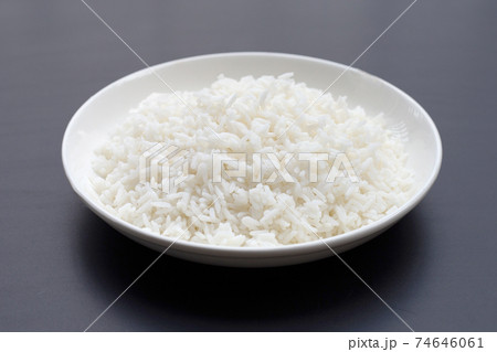 Dish of rice on dark background. 74646061